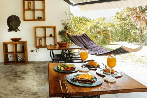 Breakfast on a covered terrace with hammock at Kooteja Coronado, a sustainable stay in Panama