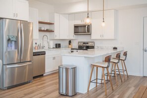 Enjoy cooking in this fully equipped kitchen with a gas stove, microwave, and refrigerator.