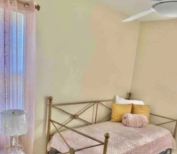 A bedroom with a bed, pillows, and a nightstand. - Spacious 5-bedroom house in Maple Heights (Maple Heights)