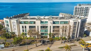 A modern building with a sign reading "MADEIRA PALACE RESIDENCES".