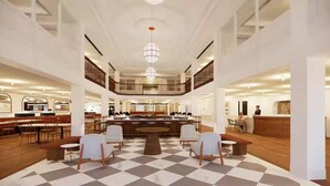 A spacious lobby with a checkered floor, a central seating area, and a reception desk. - The Hotel Monroe, Tapestry Collection By Hilton (Monroe)