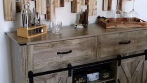 A wooden cabinet with a rustic design, featuring a black metal handle and a glass-fronted storage compartment. - Charming 3-bedroom house with WiFi, and boat parking in peaceful Tiptonville (Tiptonville)