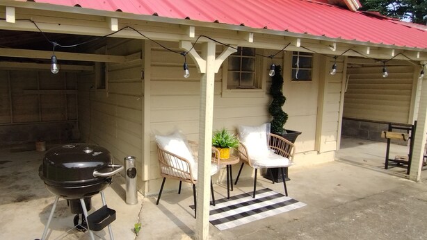 A covered outdoor area with a barbecue grill, seating, and string lights. - Charming 3-bedroom house with WiFi, and boat parking in peaceful Tiptonville (Tiptonville)