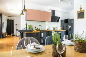 Enjoy a romantic dinner for two in this cozy dining area, complete with a beautifully set table and a fully equipped kitchen.