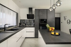 Enjoy cooking in this well-lit kitchen with a large island and sink.