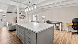 A spacious kitchen with a large island, modern appliances, and a dining area with a small table and chairs.