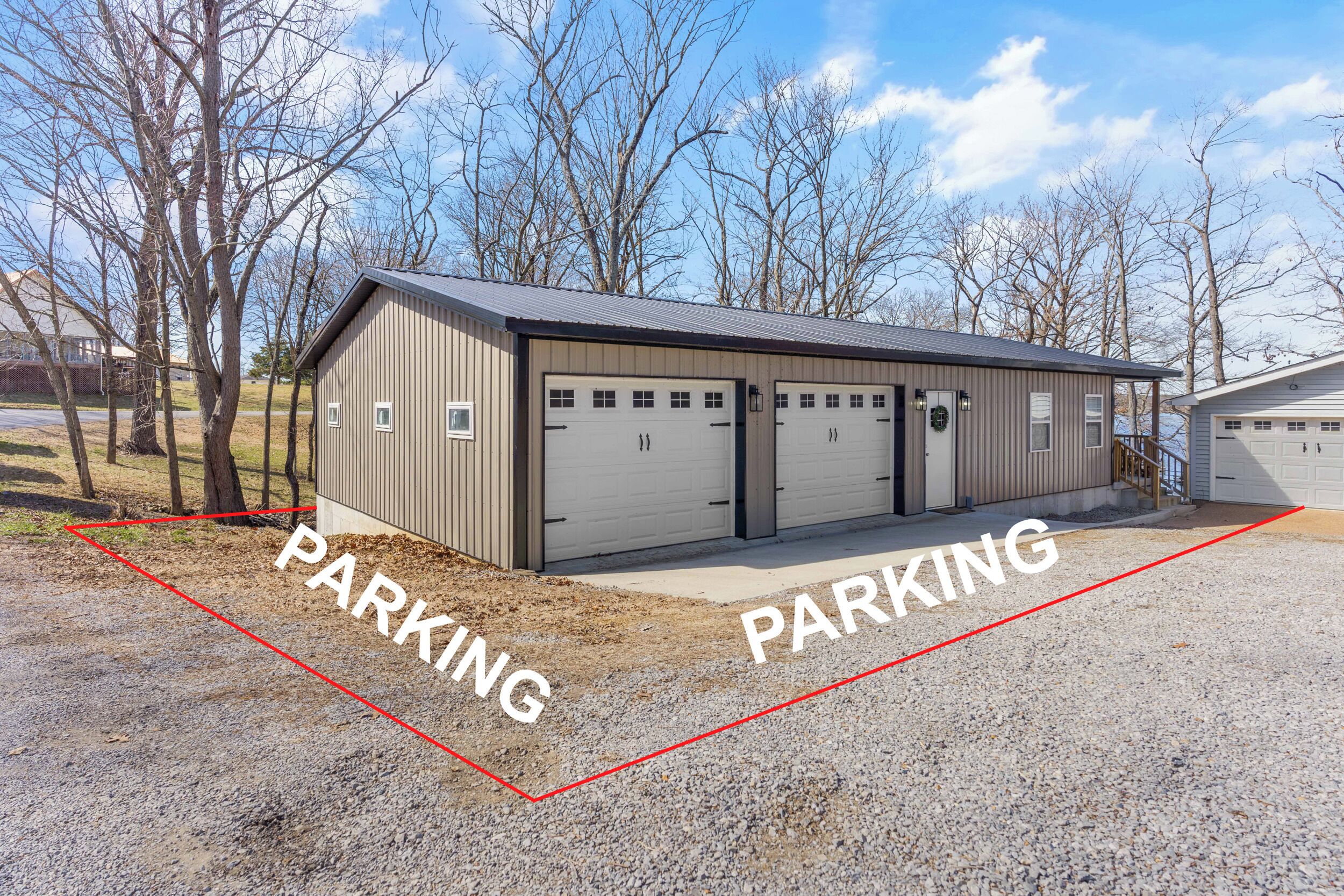 A building with two garages and a covered parking area.