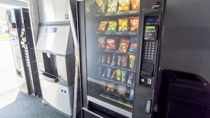 A vending machine with snacks and a payment terminal. - Hotel Inn Pendleton I-84 (Pendleton)