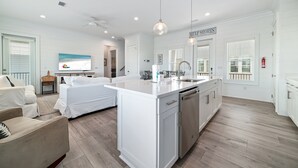 A spacious kitchen with white cabinetry, a central island, and pendant lighting. - PRIVATE HOME WITH BEACH ACCESS AND POOLS! (Gulf Shores)