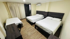 A hotel room with two single beds, a wooden desk, and a chair. - Hotel Vivanco's (Huaquillas)