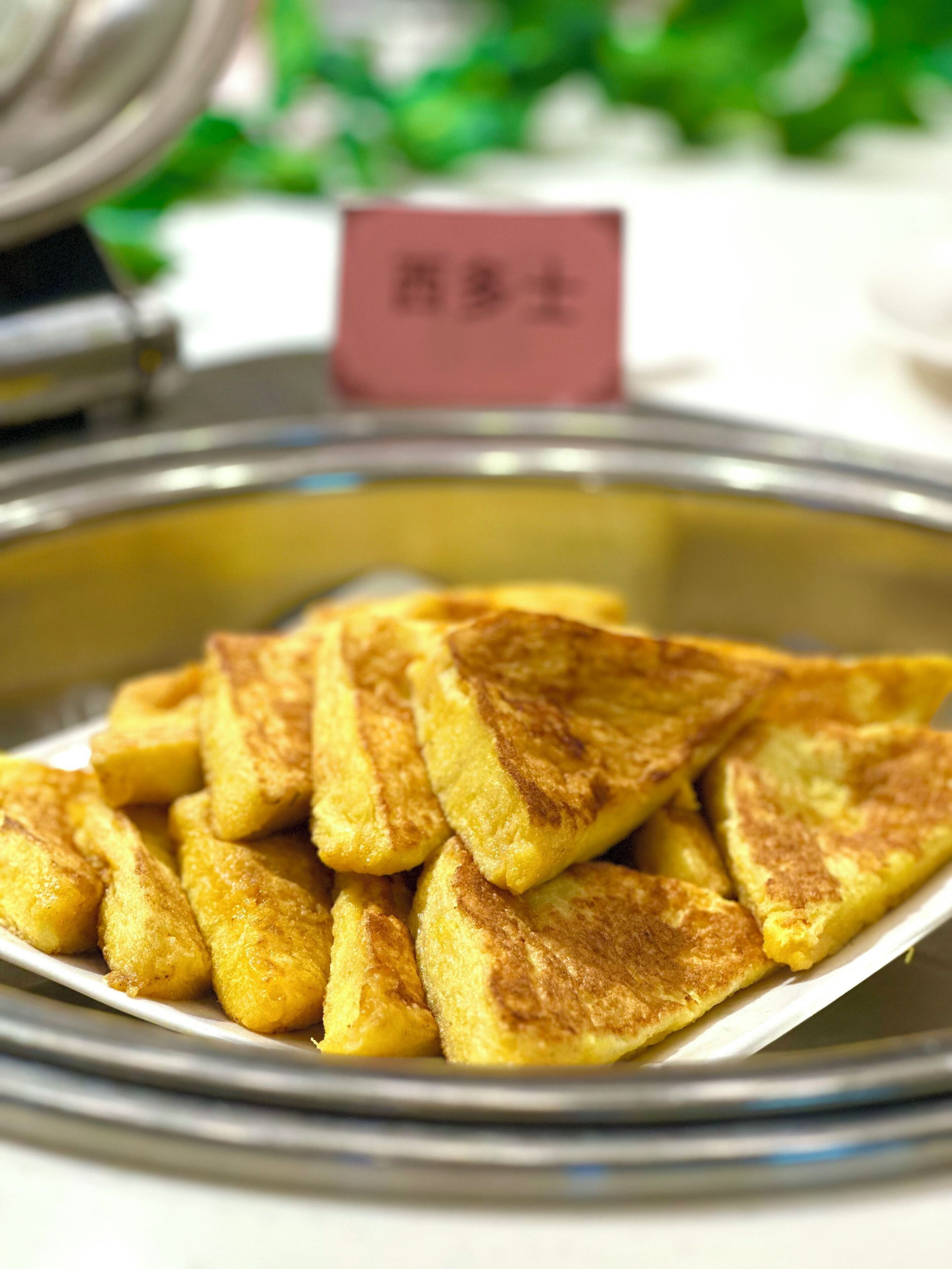 A container filled with golden-brown pancakes.