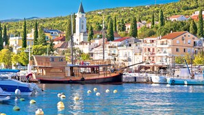A harbor with boats, a prominent clock tower, and residential buildings. - Sea View Apartment Terazza Grande, Selce, Croatia (Selce)