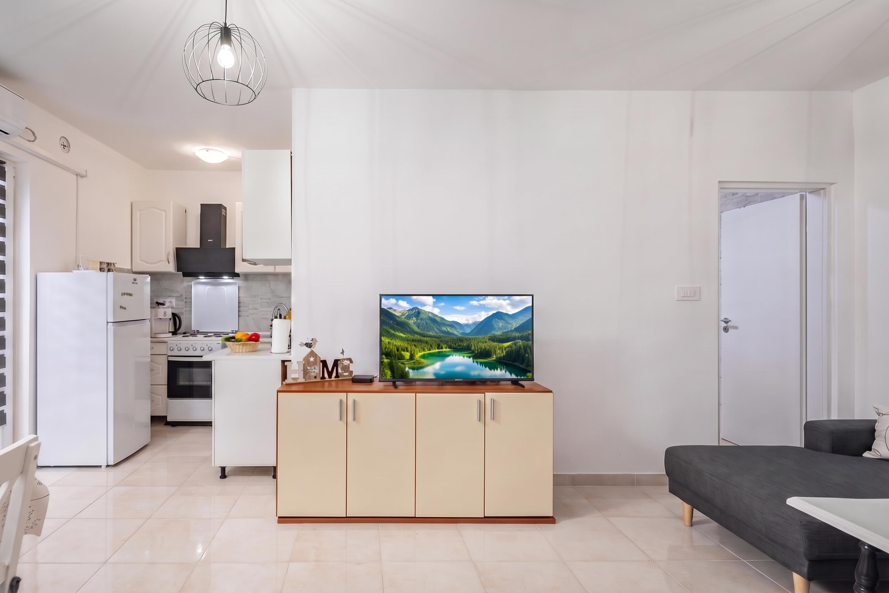 Une cuisine moderne avec des armoires blanches, un four encastré et une cuisinière.