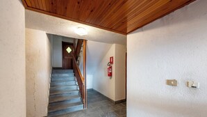 A staircase with a wooden handrail leading to a landing.