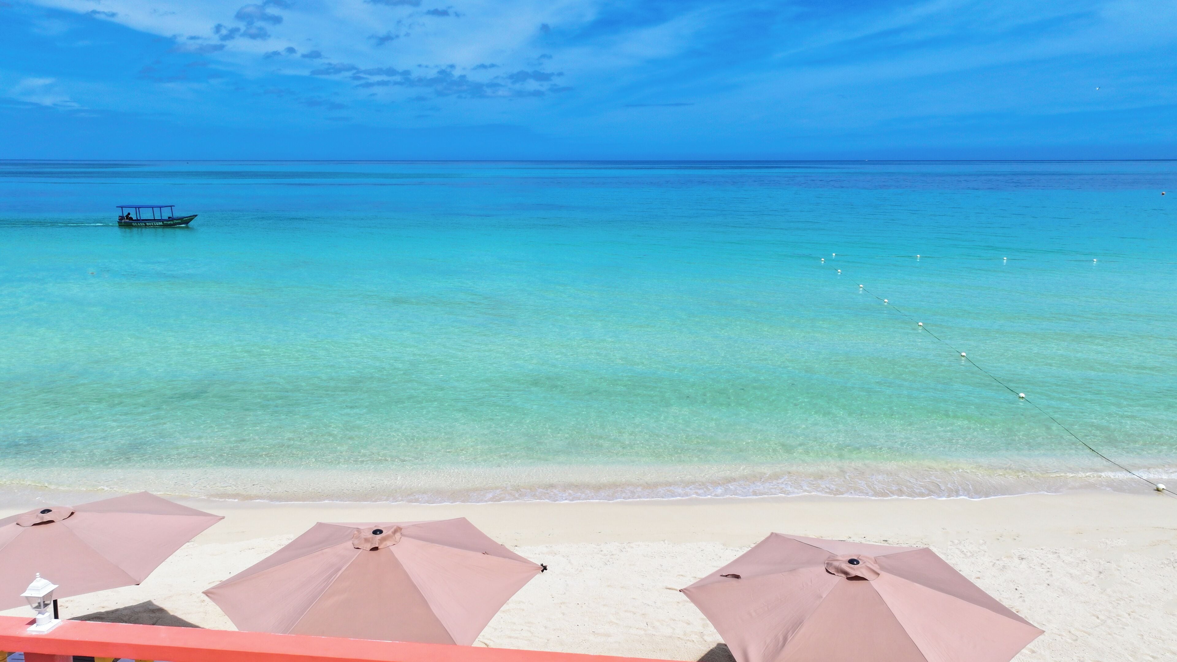 On the beach, white sand, sun-loungers