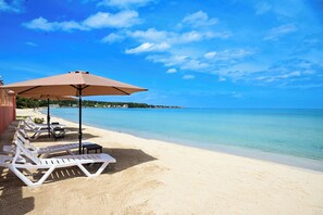 On the beach, white sand, sun loungers