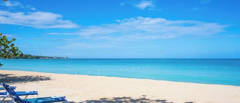 On the beach, white sand, sun loungers