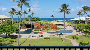A resort with a pool, palm trees, and a view of the ocean. - Beautiful Beachfront Resort with Best Ocean View Room On Property pools/hot tubs (Lihue)