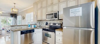 Charming townhome with ocean views, an open porch & steps from the water