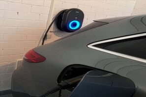 A car charging at a station with a visible blue light indicator. - Siebenstern**** Vacation Rental - 4-star vacation rental with high-speed Wi-Fi, balcony & (Winterberg)