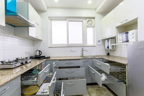 Elite Apartment, Ground Floor | Private kitchen | Microwave, oven, stovetop, cookware/dishes/utensils - Quartz -Parfait Street Near Fortis (Gurugram)