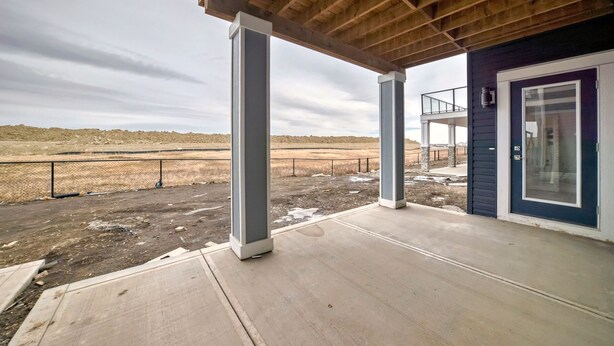 A covered porch with a view of a barren landscape. - 2 bedrooms one bath walk out basement (Calgary)