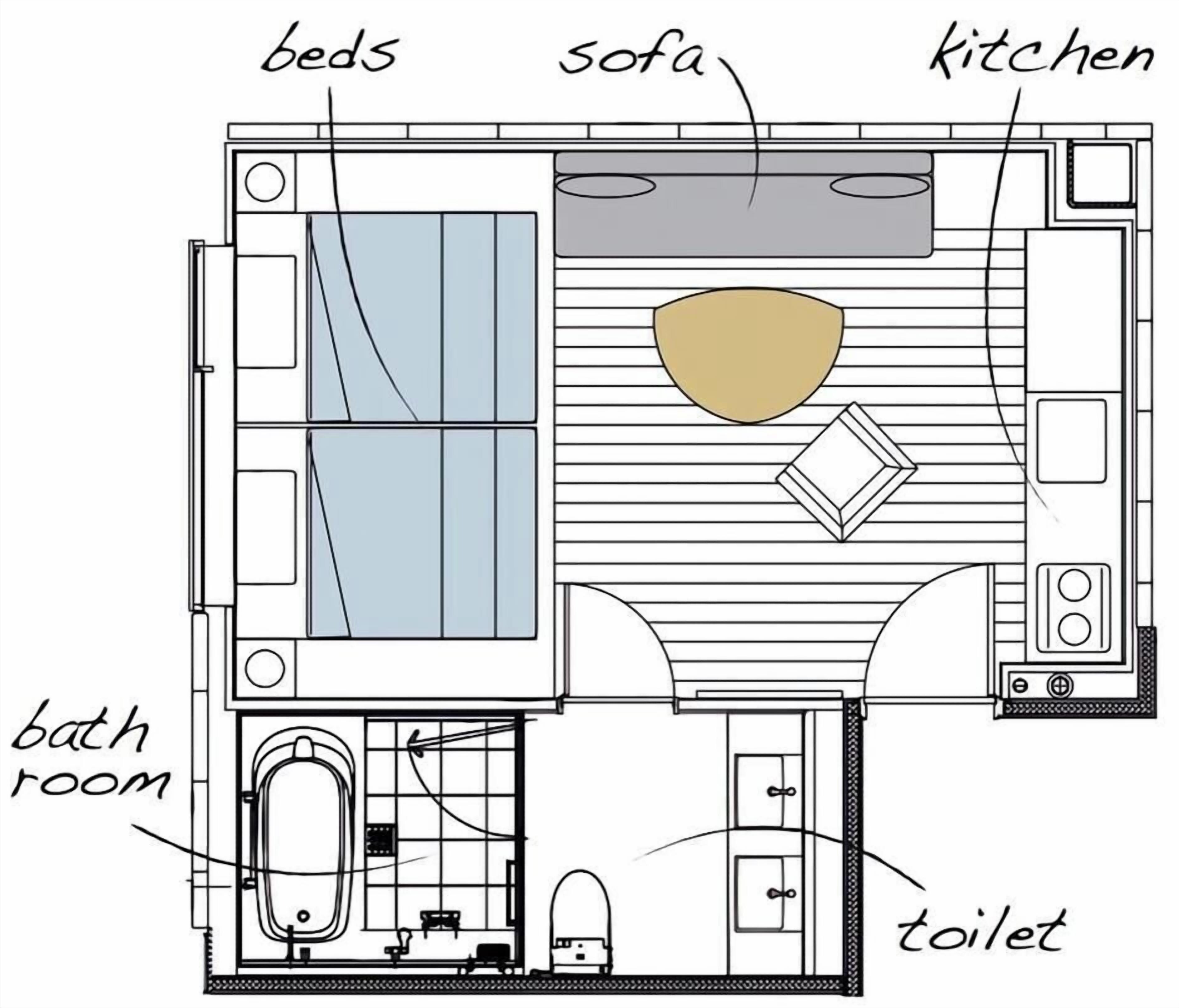 Ein Grundriss eines Hotelzimmers mit Bett, Sofa, Küche, Badezimmer und Toilette.