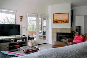 TV, fireplace, books - Bright condo with balcony, shared  pool & hot tub, central AC, fireplace (Tucson)