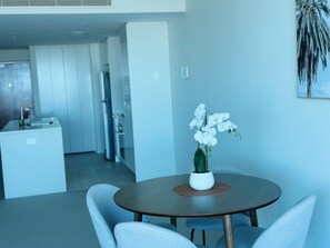 Enjoy meals in a stylish dining area with a round table and four comfortable chairs.