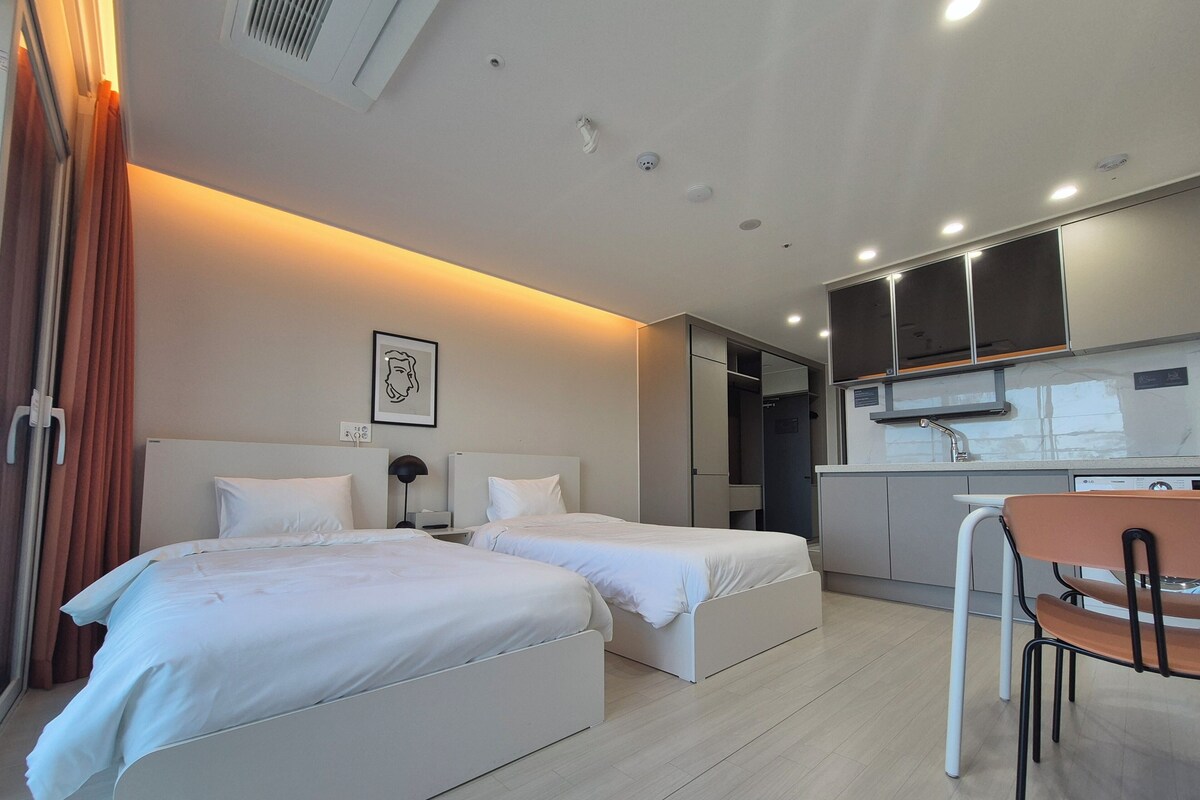 Premium bedding, desk, laptop workspace, blackout curtains