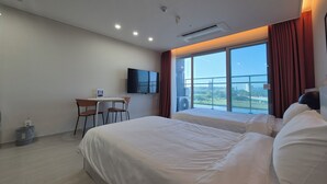 A hotel room with a large bed, a desk with a chair, a flat-screen TV, and a large window with a view. - Diamer Hotel Yangyang By Stayneo (Yangyang)