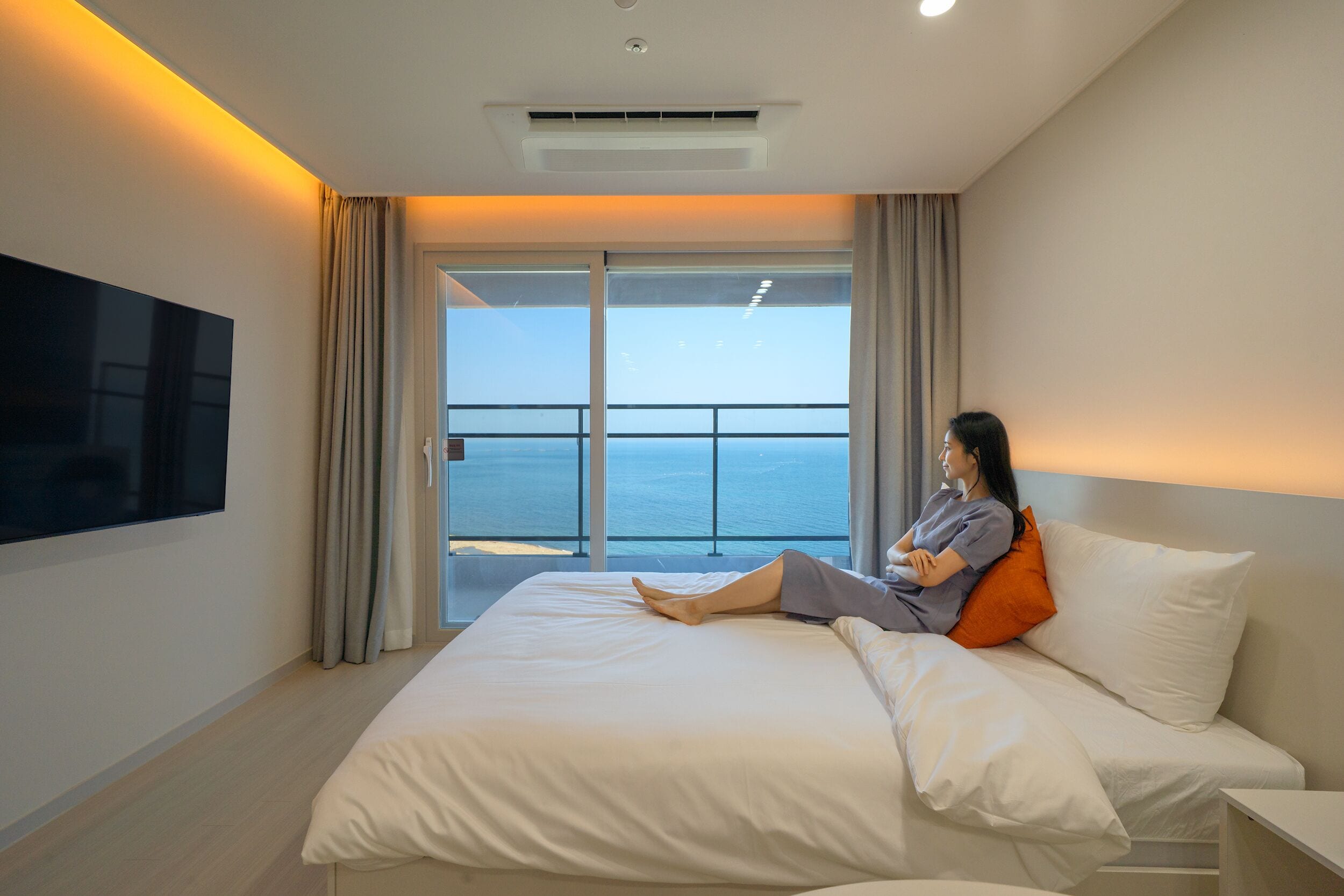 Premium bedding, desk, laptop workspace, blackout drapes