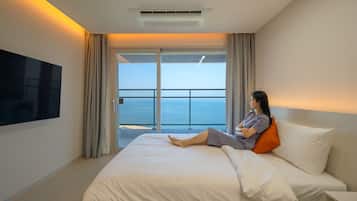 Premium bedding, desk, laptop workspace, blackout drapes