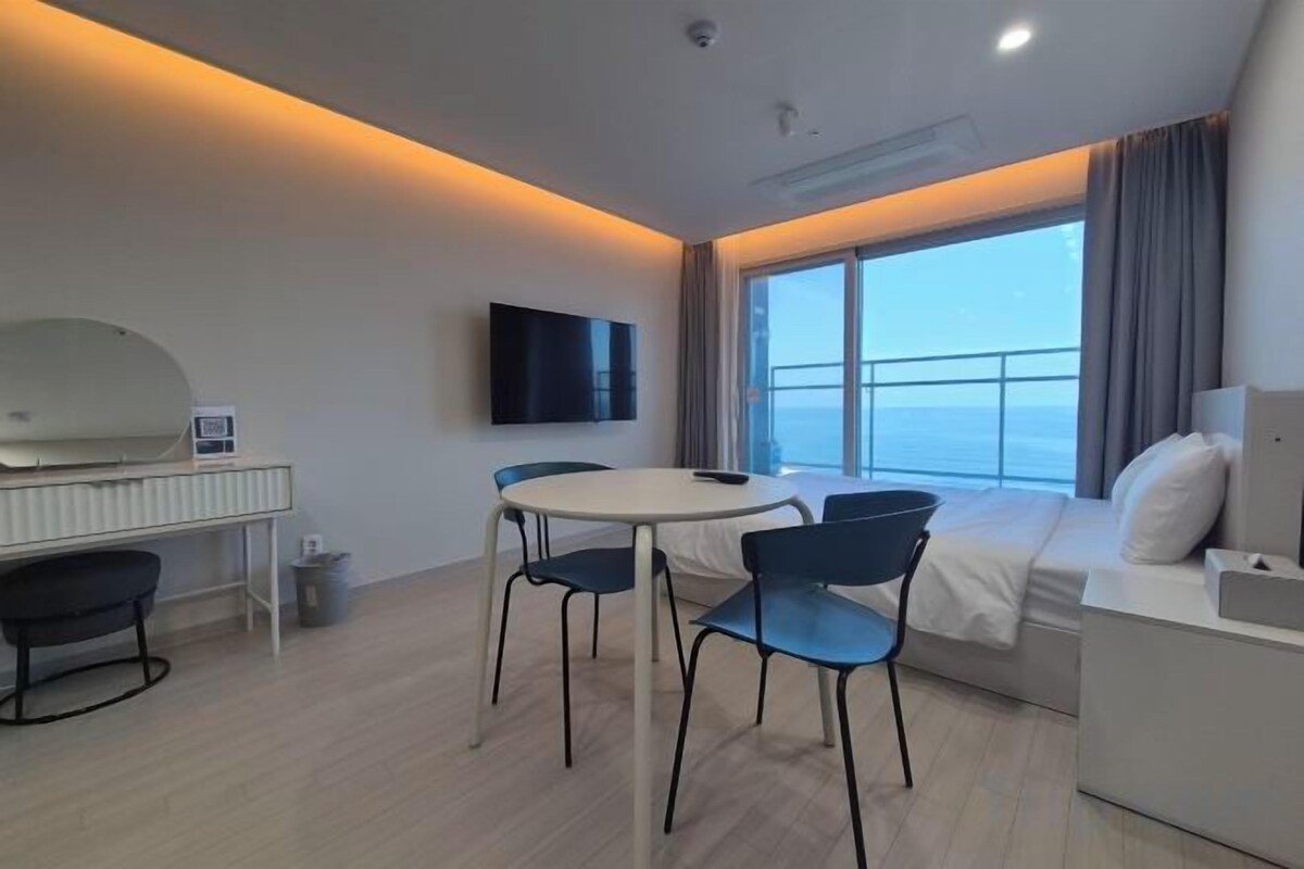 Premium bedding, desk, laptop workspace, blackout curtains