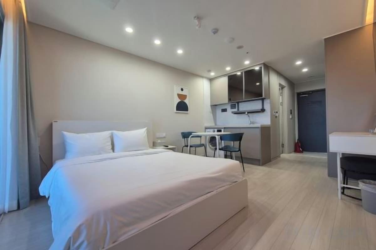 Premium bedding, desk, laptop workspace, blackout curtains