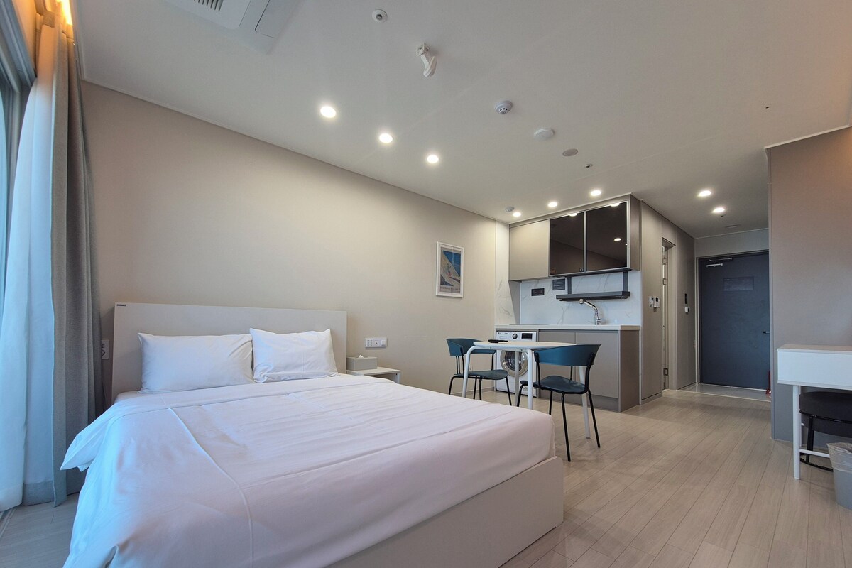 Premium bedding, desk, laptop workspace, blackout curtains