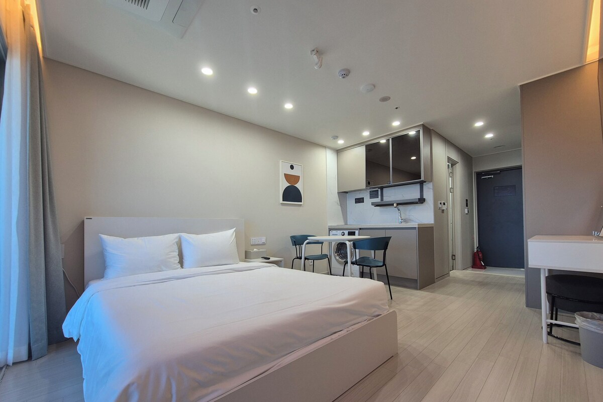 Premium bedding, desk, laptop workspace, blackout curtains