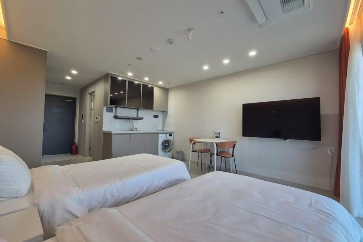 Premium bedding, desk, laptop workspace, blackout curtains