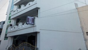 A multi-story building with a sign indicating available rooms. - ASK Grande Residency (Puducherry)