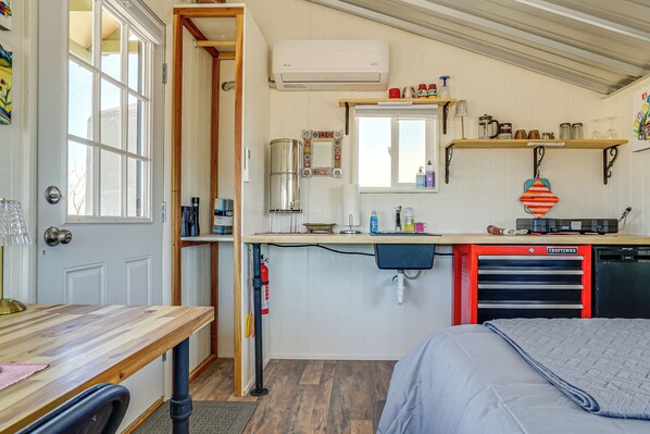 A compact kitchen with a sink, a coffee machine, and a dishwasher. - Tiny Town Cottages in Rodeo: 'Birder's Nest' (Rodeo)