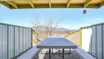 Enjoy a meal under the open sky at this outdoor dining area, surrounded by mountains.