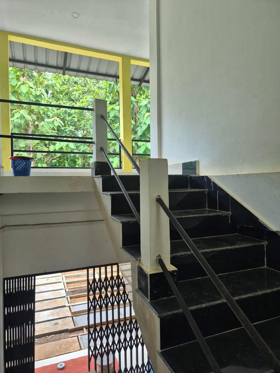 A staircase with metal railings leading to an upper floor.