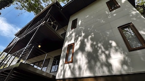 A multi-story building with a modern architectural design, featuring balconies and large windows. - Gemini Villas Gemini I (Saboga)