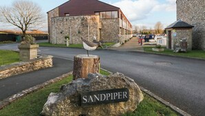 Un edificio de piedra con un letrero que dice "SANDPIPER" al frente.