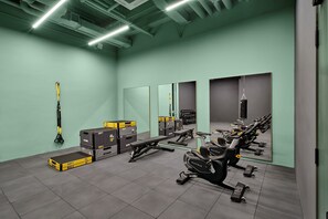 A gym with exercise equipment, weightlifting boxes, and a punching bag. - Weave Studios - Kai Tak (Kowloon)