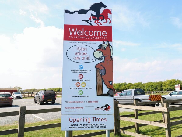 A welcome sign for Redwings Caldecott horse sanctuary with information on opening times and amenities. - 31B Foxburrow Hang (Great Yarmouth)