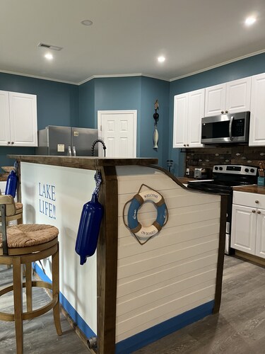 Beautiful new construction lake themed lake house with gameroom and boat bar.