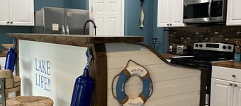 Beautiful new construction lake themed lake house with gameroom and boat bar.