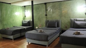 A hotel room with three beds, green walls, and a tiled floor. - Summer Club and Hostel Ao Nang (Krabi)
