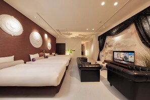 A modern hotel room with two large beds, a black leather sofa, a flat-screen TV, and decorative wall art. - minamisemba crystalplaza (Osaka)